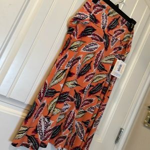 LulaRoe Azure skirt. Orange background. pink, green, black, red,yellow feathers